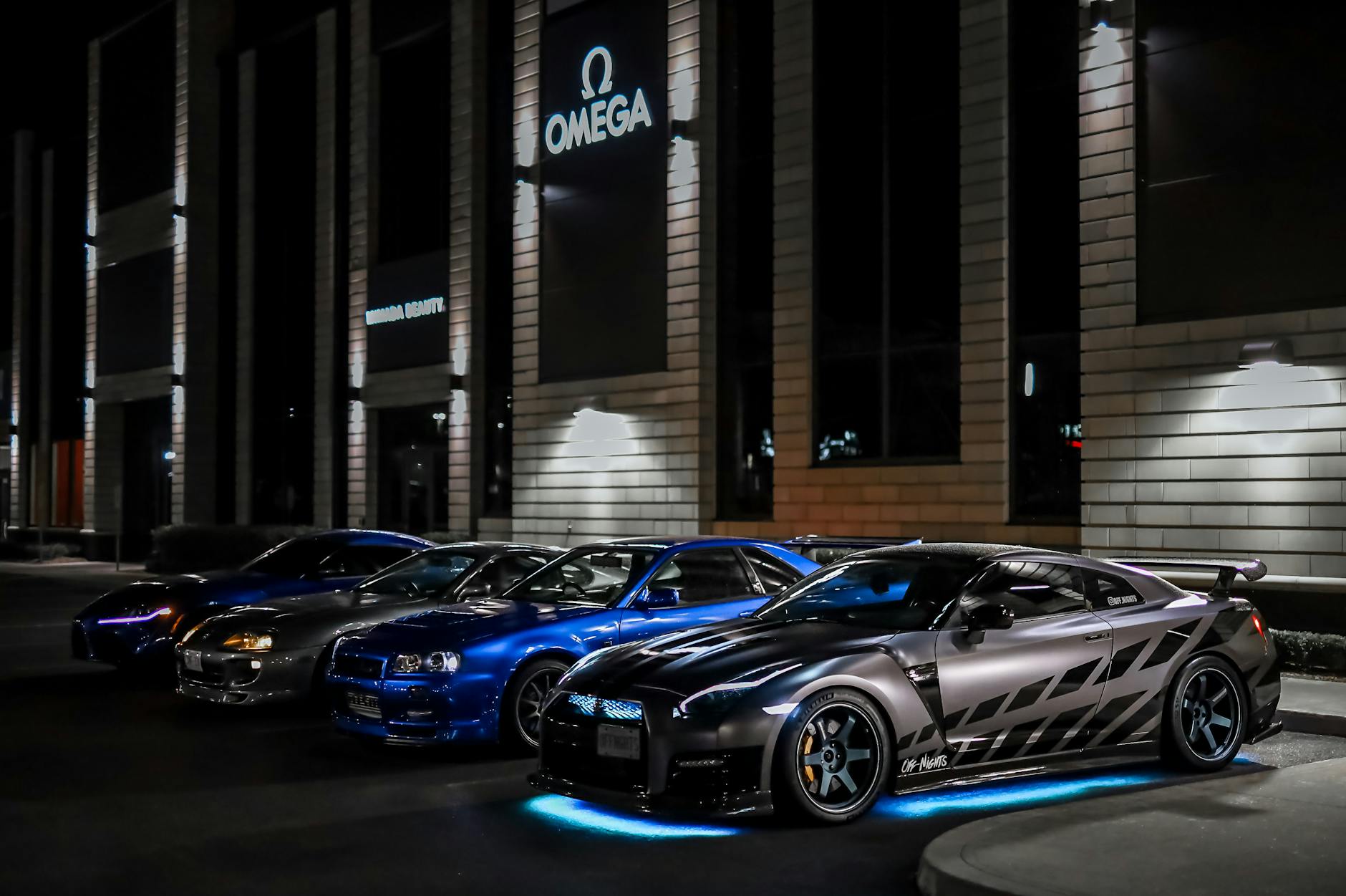 japanese sports cars on the parking lot at night